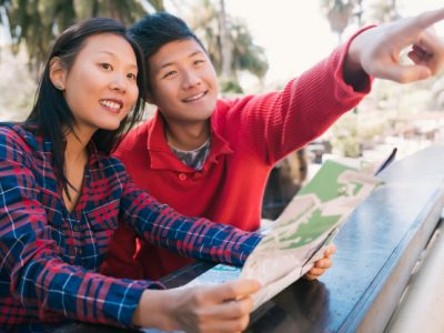 asian-traveler-couple-holding-map-looking-directions_58466-11291
