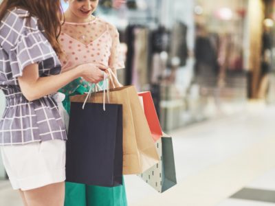 great-day-shopping-two-beautiful-women-look-bag-boast-about-what-they-bought_146671-15036